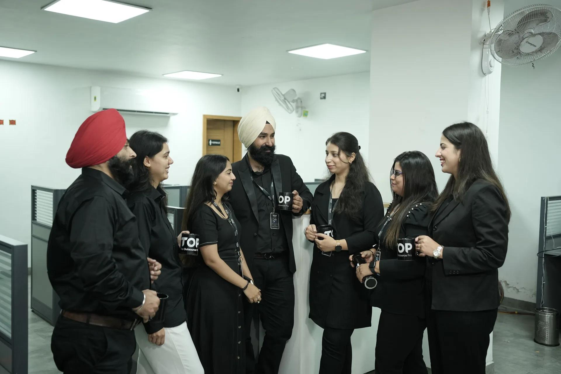 A group of TOP team members standing together in the office